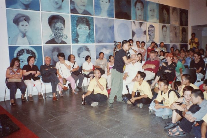 Performance by artist Nguyễn Minh Phước (the man in black Tshirt standing in front of audiences)